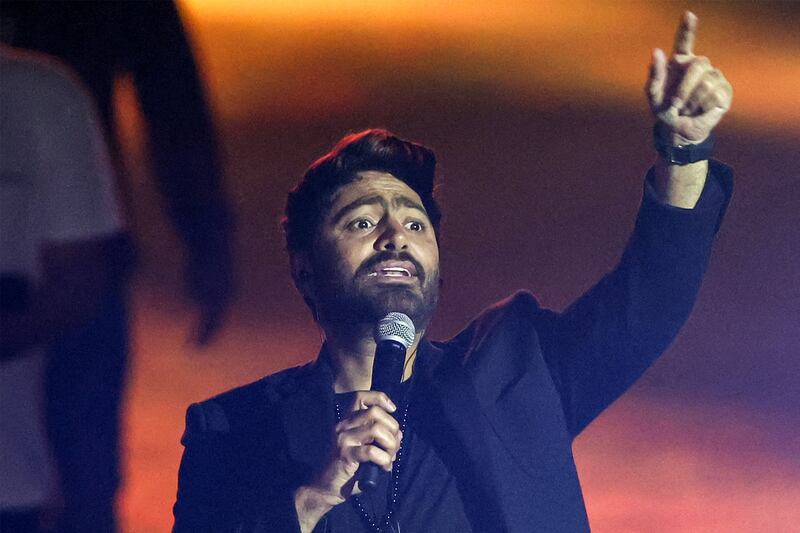 Egyptian singer Tamer Hosni performs during a free musical concert celebration ahead of the wedding of Jordan's Crown Prince at Amman International Stadium on May 29, 2023.  (Photo by Khalil MAZRAAWI  /  AFP)