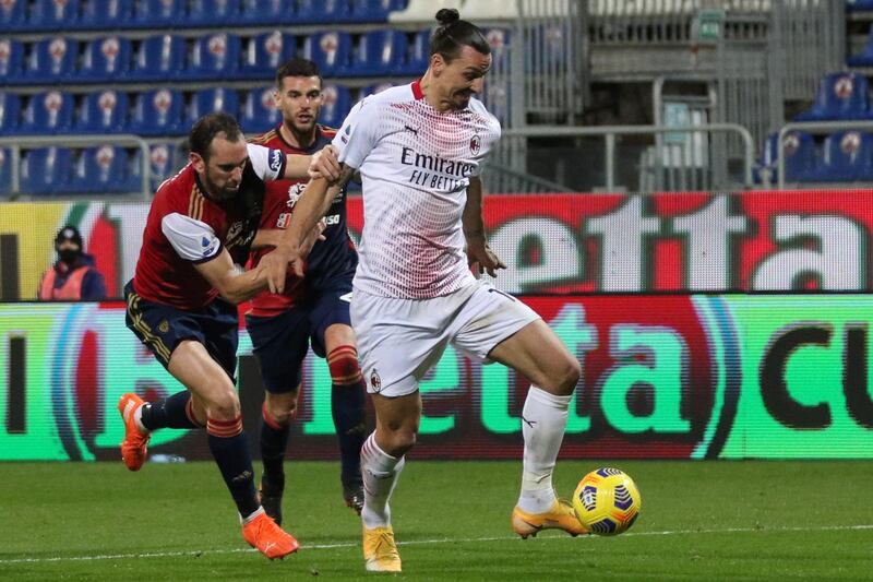 Zlatan Ibrahimovic holds off a challenge from Cagliari defender Diego Godin. EPA