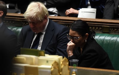 British Prime Minister Boris Johnson with Home Secretary Priti Patel in UK Parliament last month. AFP