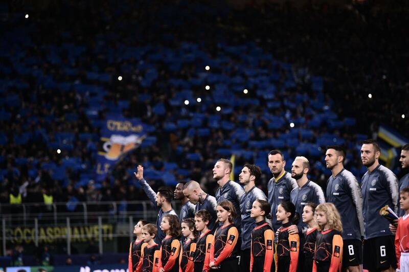 Inter Milan's goalkeeper Samir Handanovic, centre, and teammates stand at attention. AFP