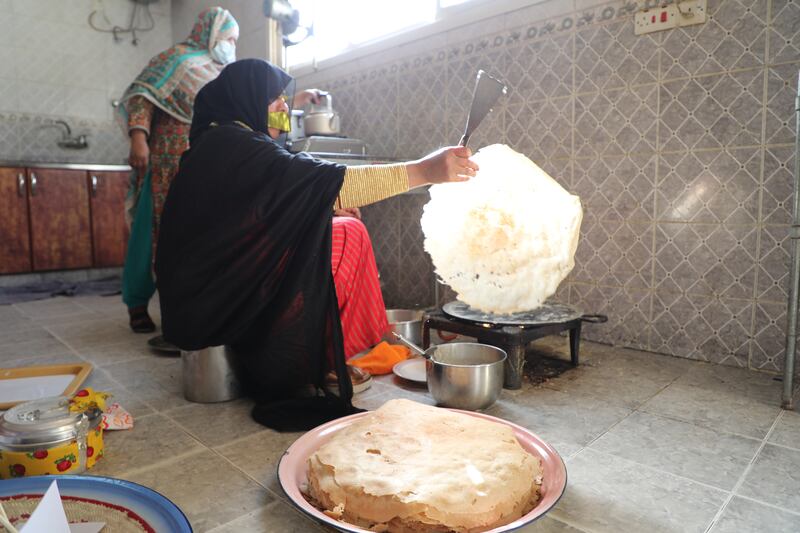 Habiba Al Mansouri preparing fresh reqaq, a traditional flat bread.