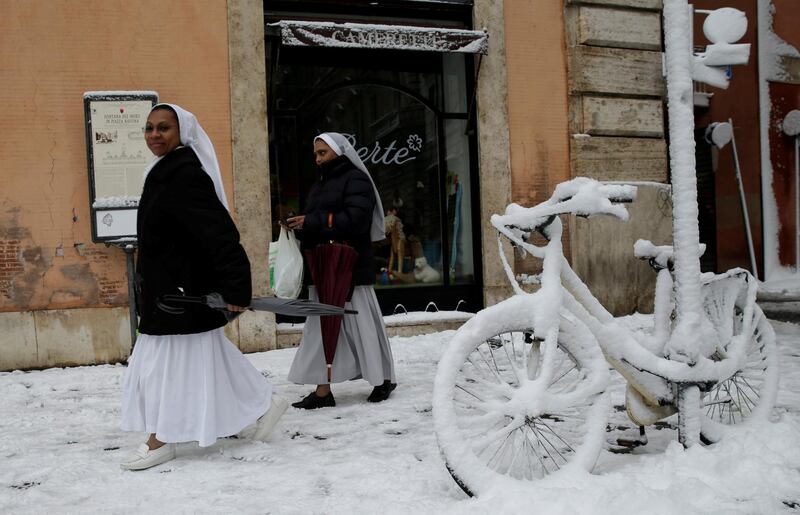 Nuns walk past a bike covered in snow during a heavy snowfall in Rome, Italy on February 26, 2018. Max Rossi / Reuters