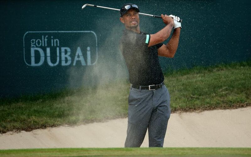 Tiger Woods hits out of a bunker during the second round of the Omega Dubai Desert Classic on Friday. Warren Little / Getty Images