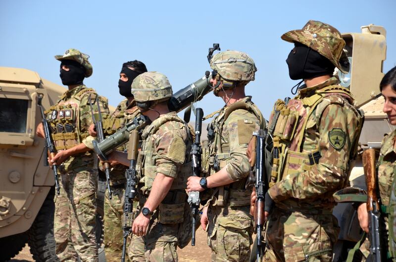 US soldiers with members of the Kurdish-led Syrian Democratic Forces in north-east Syria. EPA