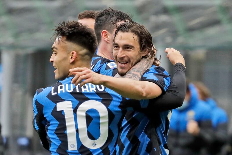 Inter Milan's Matteo Darmian, right, celebrates with teammate Inter Milan's Lautaro Martinez, left, after scoring during a Serie A soccer match between Inter Milan and Cagliari at the San Siro stadium in Milan, Italy, Sunday, April 11, 2021. (AP Photo/Luca Bruno)