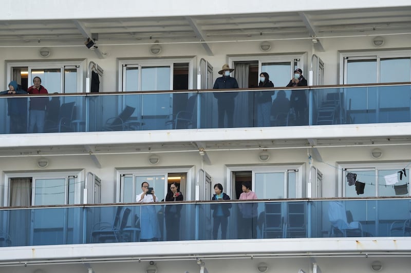 Passengers are seen on their balconies of the Diamond Princess cruise ship docked at Daikoku Pier  in Yokohama, Japan. Getty Images