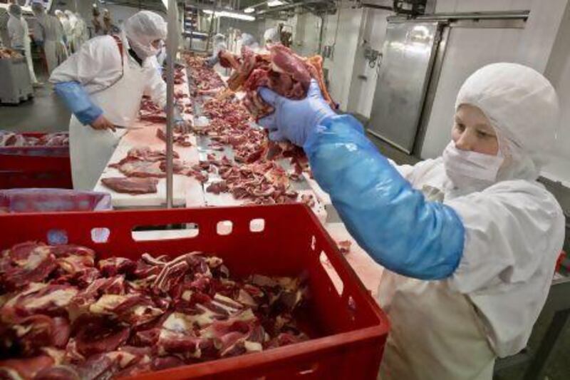 A worker handles meat at the Doly-Com abattoir, one of the two units checked by Romanian authorities in the horse meat scandal, in the village of Roma, northern Romania.