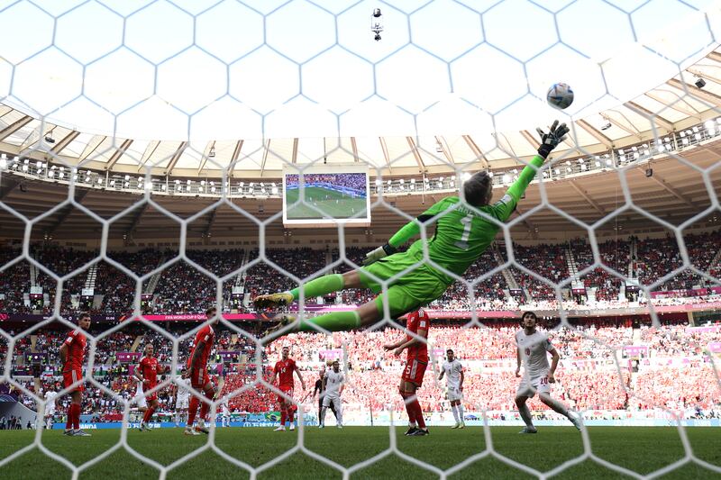 Wayne Hennessey of Wales jumps to defend an Iran attempt at goal at the Ahmad Bin Ali Stadium. Getty