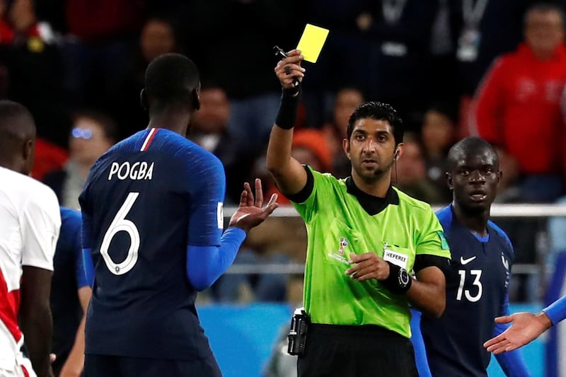 Soccer Football - World Cup - Group C - France vs Peru - Ekaterinburg Arena, Yekaterinburg, Russia - June 21, 2018   France's Paul Pogba is shown a yellow card by referee Mohammed Abdulla Hassan Mohamed    REUTERS/Damir Sagolj