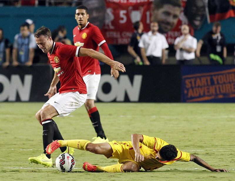 Jonny Evans, left, of Manchester United fights for control of the ball against Phillipe Coutinho of Liverpool on August 4, 2014 during the championship match in the 2014 Guinness International Champions Cup at Sun Life Stadium in Miami, Florida. Manachester Untied won 3-1. AFP PHOTO/Robert SULLIVAN
