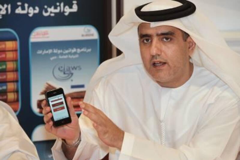 UAE - Dubai - Oct 18 - 2010: Essam Eissa al Humaidan, Attorney General, show the new iphone app from Dubai public prosecution during Gitex at Dubai International Convention Centre. ( Jaime Puebla - The National Newspaper )