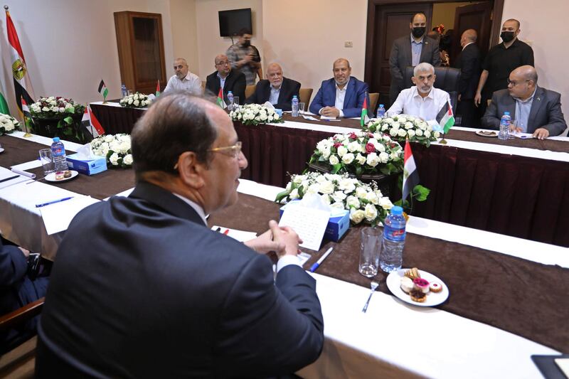 Yehiyeh Sinwar, second from right sitting at rear, the top Hamas leader in Gaza, and the head of the Egyptian General Intelligence Abbas Kamel, foreground, meet in Gaza City, Monday, May 31, 2021. (AP Photo/Ashraf Amra, Pool)