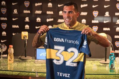 Boca Juniors' newly returned player Carlos Tevez poses with his new jersey during his official presentation at Los Cardales, Buenos Aires province, on January 09, 2018. 
Former Manchester United and Juventus striker Carlos Tevez agreed a move back to boyhood club Boca Juniors for the third time in his carreer. / AFP PHOTO / EITAN ABRAMOVICH