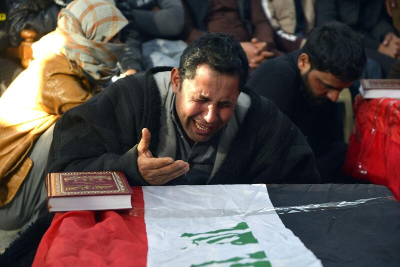 Iraqis mourn over the coffins, clad in their national flag, of six people who were reportedly abducted and killed, during their funeral in the central holy city of Najaf, on February 20, 2019.  Iraqi security forces yesterday found the bodies of six out of 12 people who were abducted a few days earlier southwest of Baghdad, an official said.
According to Iraqi security forces, "Armed men on motorbikes" abducted the group on 17, February, as they collected truffles in the Al-Nukhaib region in the desert between Najaf and Al-Anbar provinces. / AFP / Haidar HAMDANI
