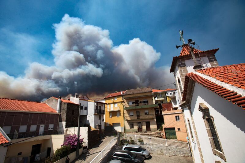 Smoke from a forest fire over the village of Verdelhos in the Beijames glacial valley, Castelo Branco, Portugal. Almost 600 fire personnel, 205 vehicles and 13 aeroplanes are battling the fire. EPA