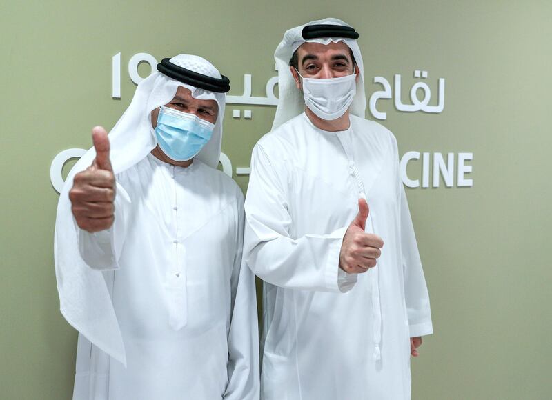 Abu Dhabi, United Arab Emirates, December 13, 2020.   Doctors and UAE residents get Covid-19 vaccinated at the Burjeel Hospital, Al Najdah Street, Abu Dhabi.  Jaber Humaid, left and Omran Al Khoori after getting their vaccinations at the clinic.
Victor Besa/The National
Section:  NA