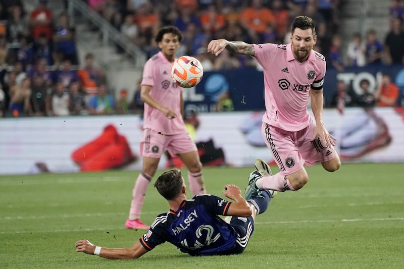  Lionel Messi tries to avoid a tackle from FC Cincinnati defender Bret Halsey. AP
