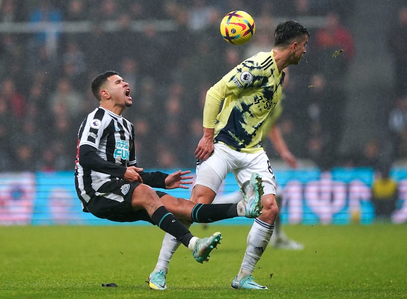 Newcastle midfielder Bruno Guimaraes is fouled by Leeds' Marc Roca. PA