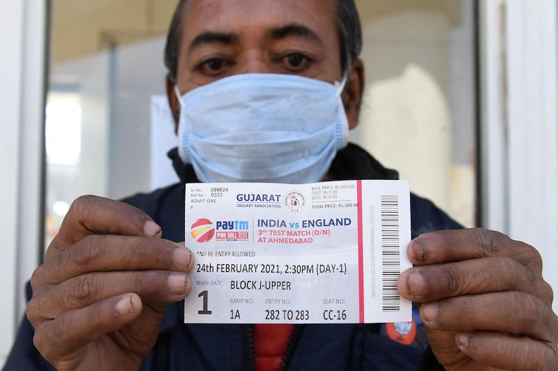 A fan shows his match ticket outside the Sardar Patel Stadium. AFP