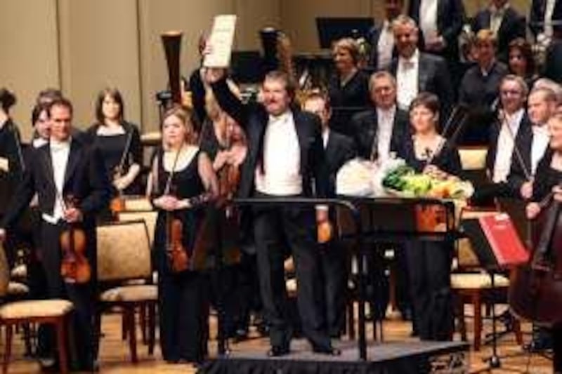 ABU DHABI. 10th Jan.2009 .Conductor Maxim Shostakovich , the son of composer Dmitri Shostakovich, holds up his father's music at the end of the classical concert with the Philharmonia Orchestra,London , at the Emirates Palace hotel . (saturday)  Stephen Lock  /  The National. 