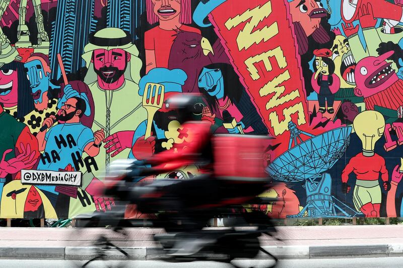 Dubai, United Arab Emirates - Reporter: N/A: Standalone. Scooters dive passed the colourful artwork that covers the Media City amphitheater. Tuesday, 3rd of March, 2020. Media City, Dubai. Chris Whiteoak / The National