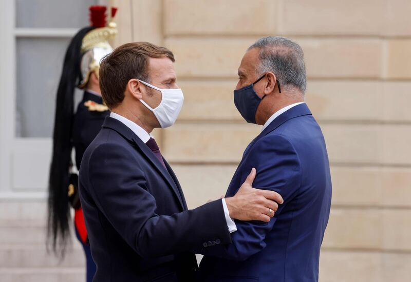 Prime Minister of Iraq Mustafa al-Kadhimi is welcomed by France's President Emmanuel Macron ahead of a working lunch at the Elysee Palace in Paris.  AFP