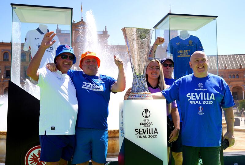 Rangers fans have their photo taken with the Europa League trophy at the Plaza de Espana in Seville. PA