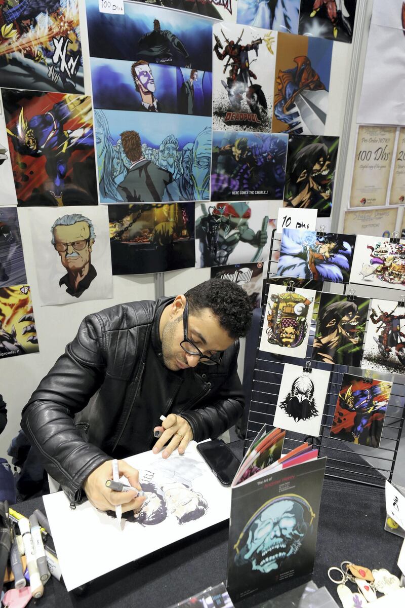 Dubai, United Arab Emirates - April 11, 2019: Artist Andrew Henry draws a portrait at the Middle East Film and Comic Con. Thursday the 11th of April 2019. World Trade Centre, Dubai. Chris Whiteoak / The National