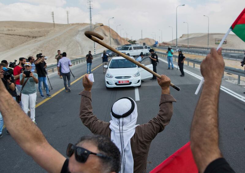 FILE - In this Friday, Sept. 7, 2018 file photo, protesters block the traffic on the highway passing near the West Bank Bedouin community of Khan al-Ahmar. Major European countries issued a rare joint statement warning Israel against its planned demolition of the Bedouin encampment in the West Bank. France, Germany, Italy, Spain and the United Kingdom said Monday, Sept. 10, 2018, that its strategic location is important to maintain "contiguity of a future Palestinian state." (AP Photo/Nasser Nasser, File)