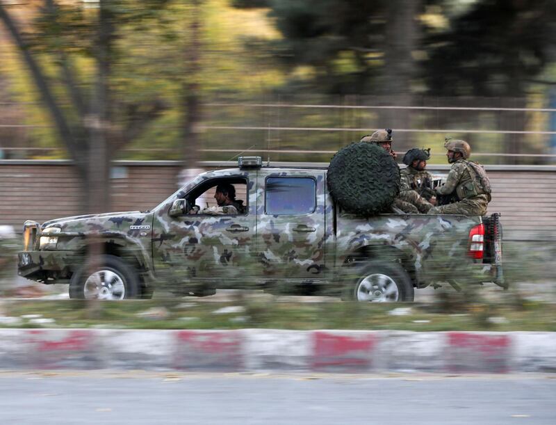 Afghan security forces leave the site of an incident after an attack at the university of in Kabul. REUTERS