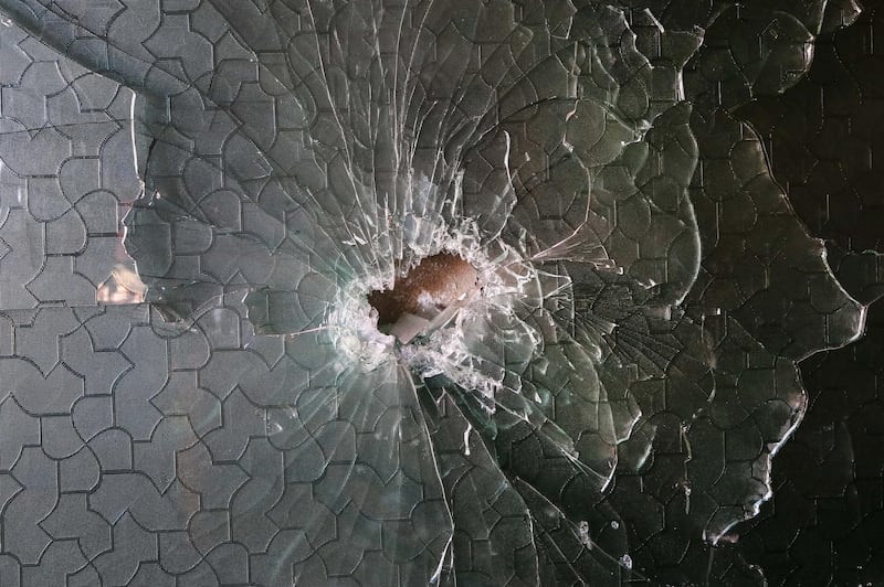 A shrapnel hole in a glass at the site of a rocket attack at a residential house in Kabul, Afghanistan December 12, 2020. EPA