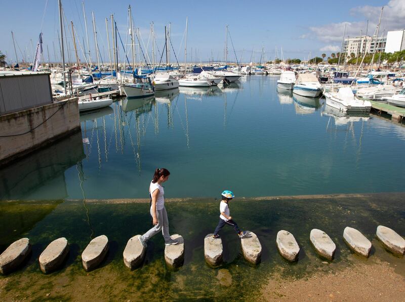 A woman and her son walk at the Yacht Club Portixol in Palma de Mallorca during a national lockdown to prevent the spread of the COVID-19 disease. After six weeks stuck at home, Spain's children were being allowed out today to run, play or go for a walk as the government eased one of the world's toughest coronavirus lockdowns. Spain is one of the hardest hit countries, with a death toll running a more than 23,000 to put it behind only the United States and Italy despite stringent restrictions imposed from March 14, including keeping all children indoors. Today, with their scooters, tricycles or in prams, the children accompanied by their parents came out onto largely deserted streets.  AFP
