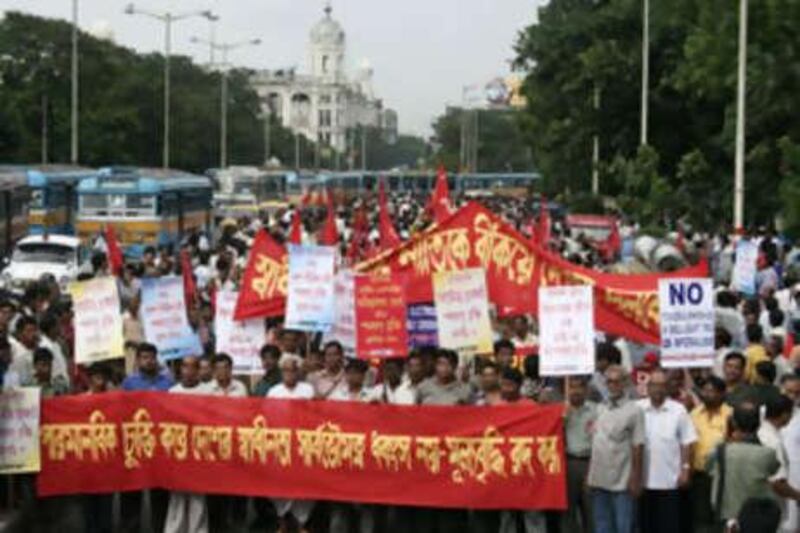 Left Front supporters walk in a protest rally against proposed nuclear deal, in Calcutta, India, on July 10, 2008. Communist allies withdrew support to Indian prime minister Manmohan Singh's four-year-old coalition government, paving the way for the government to go ahead with a controversial civilian nuclear deal with the US. The banner reads: "Stop inflation - do not exchange freedom and sovereignty for nuclear deal.