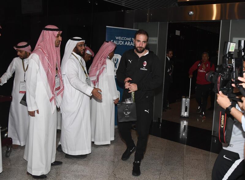 AC Milan striker Gonzalo Higuain gets off the team bus at Jeddah King Abdulaziz International Airport. Getty Images