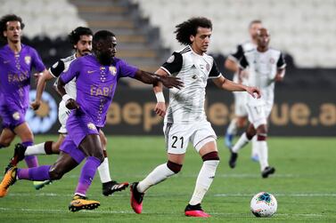 ABU DHABI, UNITED ARAB EMIRATES , March 14 – 2020 :- Ahmed Barman (no 13 purple) of Al Ain and Omar Abdulrahman (no 21 white) of Al Jazira in action during the Arabian Gulf League football match between Al Jazira v Al Ain held at Mohamed bin Zayed Stadium in Abu Dhabi. (Pawan Singh / The National) For Sports. Story by John