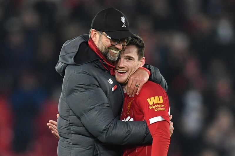 Liverpool manager Jurgen Klopp embraces defender Andrew Robertson at the end of the match. AFP