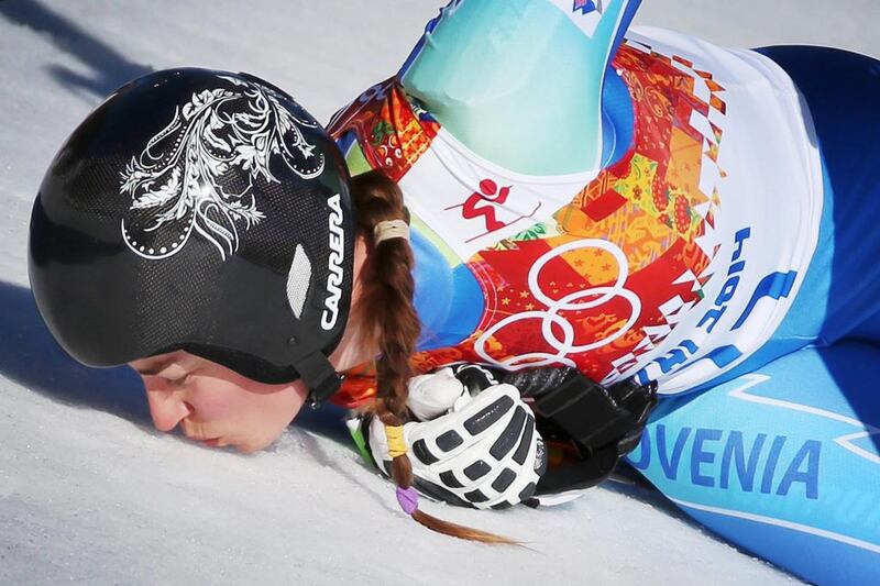 Tina Maze of Slovenia kisses the snow in the finish area after her run in the women's downhill race at the Rosa Khutor Alpine Center on Wednesday. Fredrik Von Erichsen / EPA