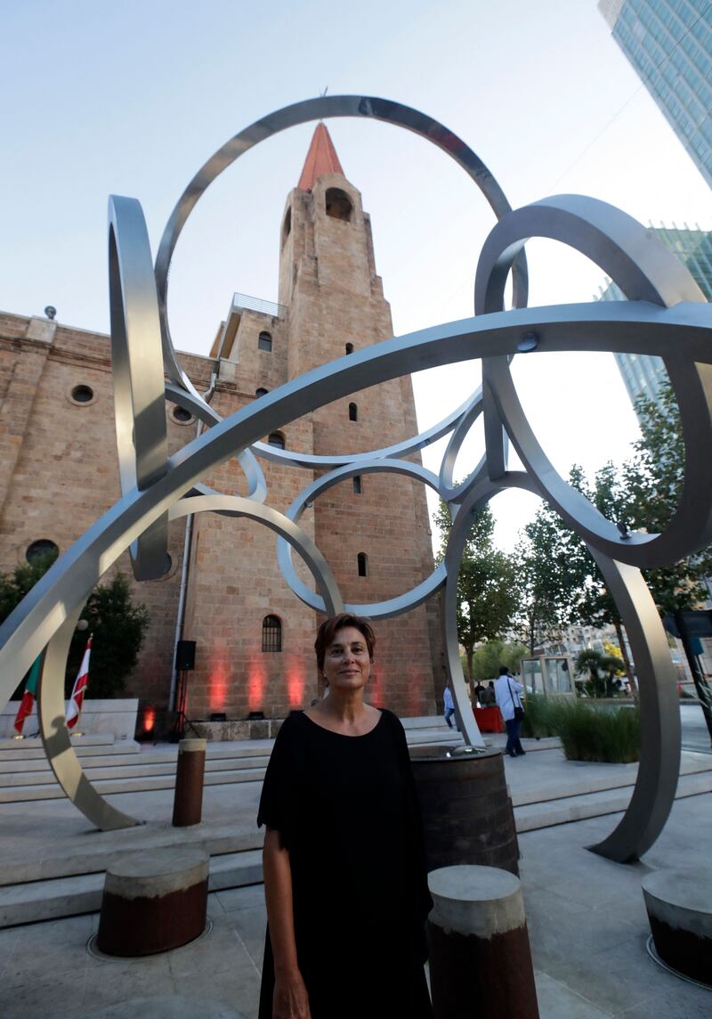 Ms Iliya poses in front of her sculpture, illustrating the sheer scale of the piece.
