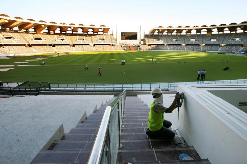 Abu Dhabi, United Arab Emirates --- November 9, 2009 --- Workers putting on finishing touches at Zayed Sports City stadium.  ( Delores Johnson / The National ) *** Local Caption ***  dj_09nov09_na_stadium_018.jpg