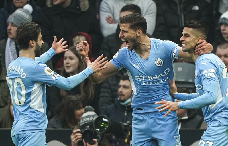 Manchester City's Ruben Dias, centre, celebrates scoring the first goal against Newcastle at St. James' Park on December 19, 2021. PA