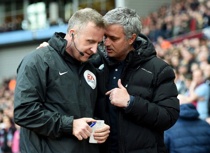 Jose Mourinho talks to fourth official Jonathan Moss before Chelsea's match on Saturday. Michael Regan / Getty Images / March 15, 2014 