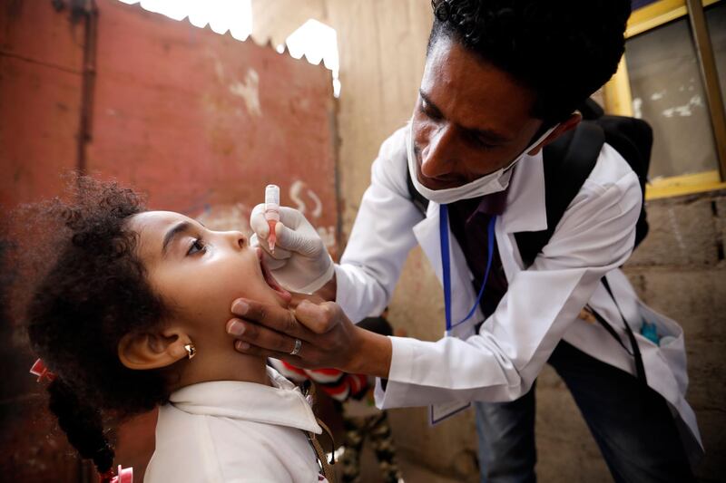 A health worker administers a polio vaccine to a child during an emergency polio vaccination campaign at a neighbourhood in Sana'a, Yemen. According to reports, a door-to-door emergency polio vaccination campaign was launched in northern Yemen to vaccinate more than five million children under the age of five, a few months after a polio outbreak was declared in the north-west of the war-torn country. EPA