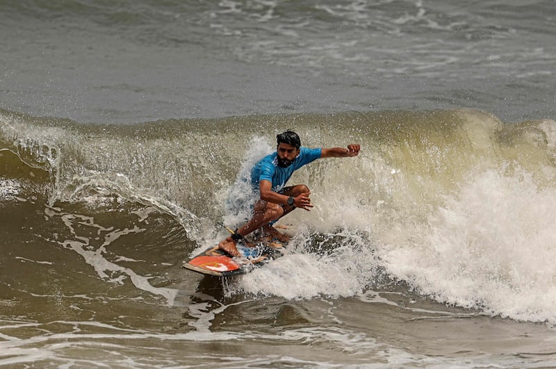 A Palestinian surfer rides a wave off the Gaza City coast. All photos by AFP