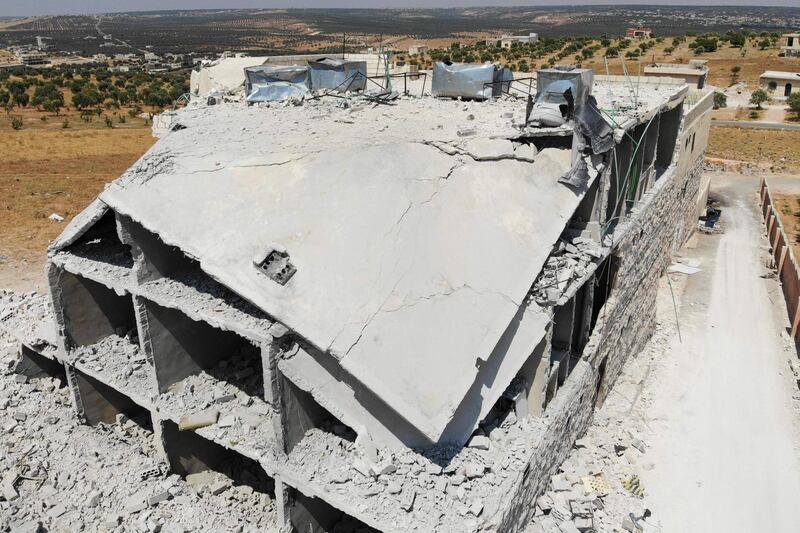 TOPSHOT - This aerial view taken on August 5, 2019 shows a view of damaged and destroyed buildings in the town of Maaret Hurmah in the southern countryside of Syria's northwestern Idlib province.  / AFP / Omar HAJ KADOUR
