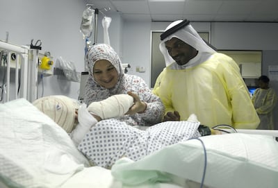 Abu Dhabi, United Arab Emirates - From left, Um Saeed, mother and Obeid Saeed, the grandfather takes care of Sheikha Saeed, two year old, badly burned after a pressure cooker explosion in the kitchen, and is admitted at Mafraq Hospital on May 31, 2018. (Khushnum Bhandari/ The National)