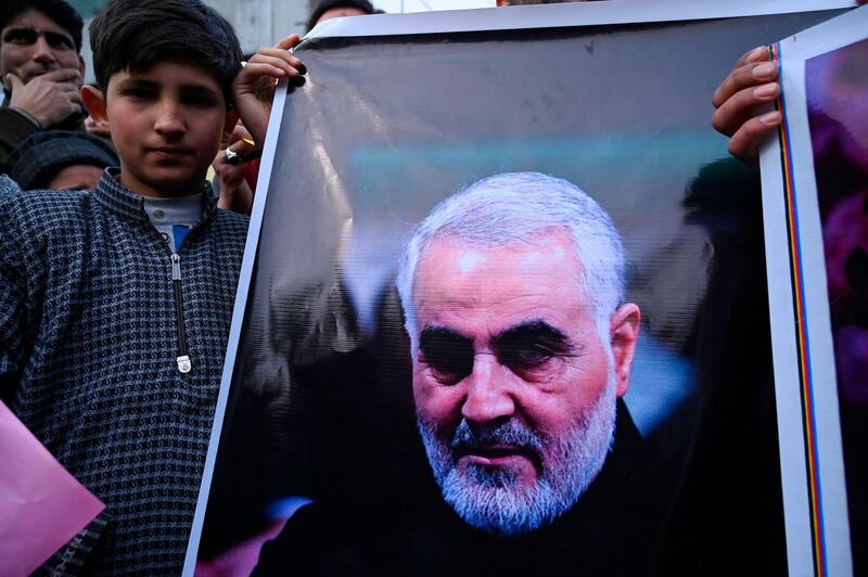 A protester holds a poster with the image of top Iranian commander Qasem Soleimani, who was killed in a US airstrike in Iraq, in the Kashmiri town of Magam on January 3, 2020. Hundreds of people in Indian Kashmir staged "anti-American" demonstrations in the troubled territory on January 3 within hours of US forces killing a top Iranian commander.
 / AFP / Tauseef MUSTAFA
