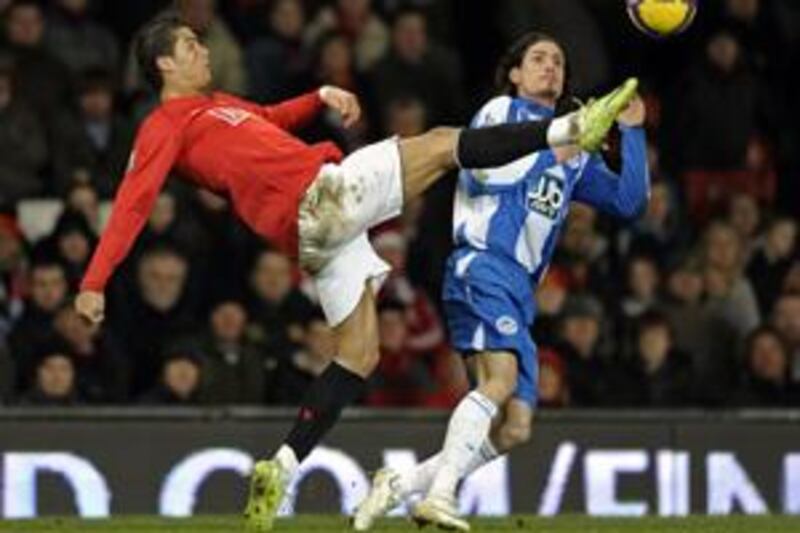 Cristiano Ronaldo, left, who set up United's solitary strike at Old Trafford, reaches for the ball ahead of Wigan's Daniel De Ridder.