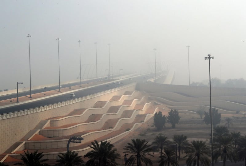 Abu Dhabi - United Arab Emirates - 22Dec2017 - Shaikh Zayed bridge covered with dense fog engulfed Abu Dhabi city in the morning having poor visibilty for motorist. Ravindranath K / The National