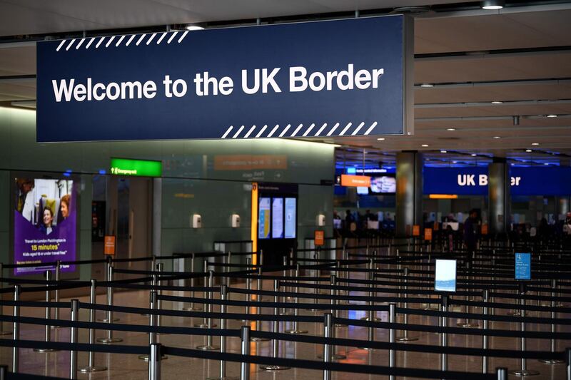 (FILES) This file photograph taken on July 16, 2019, shows a UK border sign at the passport control in The Arrivals Hall of Terminal 2 at Heathrow Airport, west of London. Britain is to introduce 14 days quarantine for international arrivals, Northern Ireland secretary Brandon Lewis confirmed on May 22, 2020, and said ministers would give further details later. / AFP / Daniel LEAL-OLIVAS
