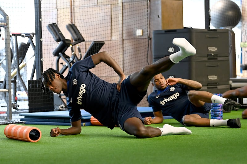 Chelsea defender Trevoh Chalobah stretched during a warm up in the gym before a training session at Chelsea training ground.
